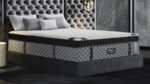 Luxurious modern mattress in sleek bedroom with plush headboard and soft lighting.