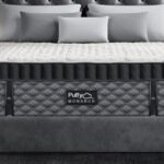 Luxurious Puffy MONARCH mattress on elegant bed in modern, serene gray bedroom.