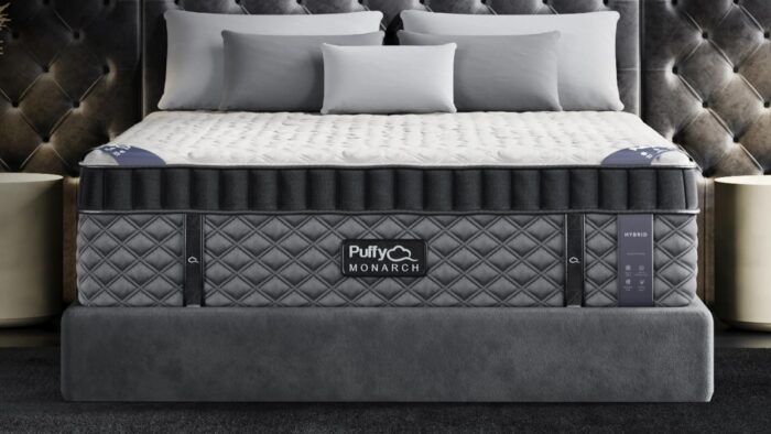 Luxurious Puffy MONARCH mattress on elegant bed in modern, serene gray bedroom.