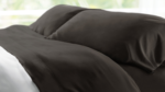 Luxurious dark brown bedding set with elegant pillows and cozy ambiance.