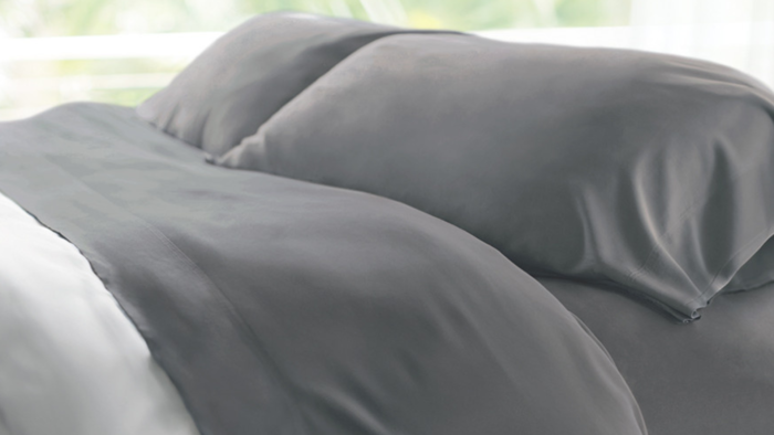 Luxurious gray bedding for a serene, modern, and inviting bedroom atmosphere.