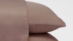 Luxurious brown pillowcases with lustrous finish, enhancing bedroom decor and comfort.