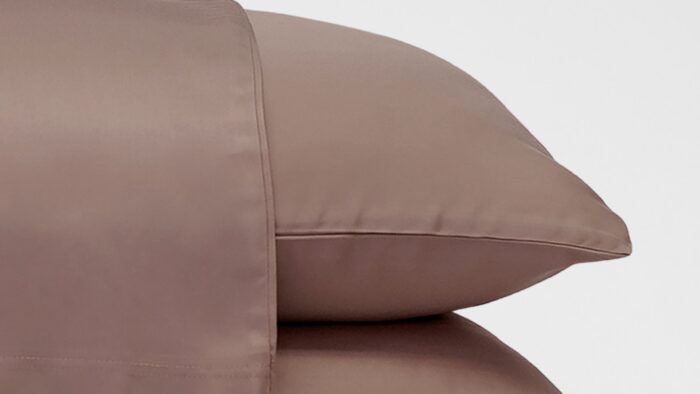 Luxurious brown pillowcases with lustrous finish, enhancing bedroom decor and comfort.