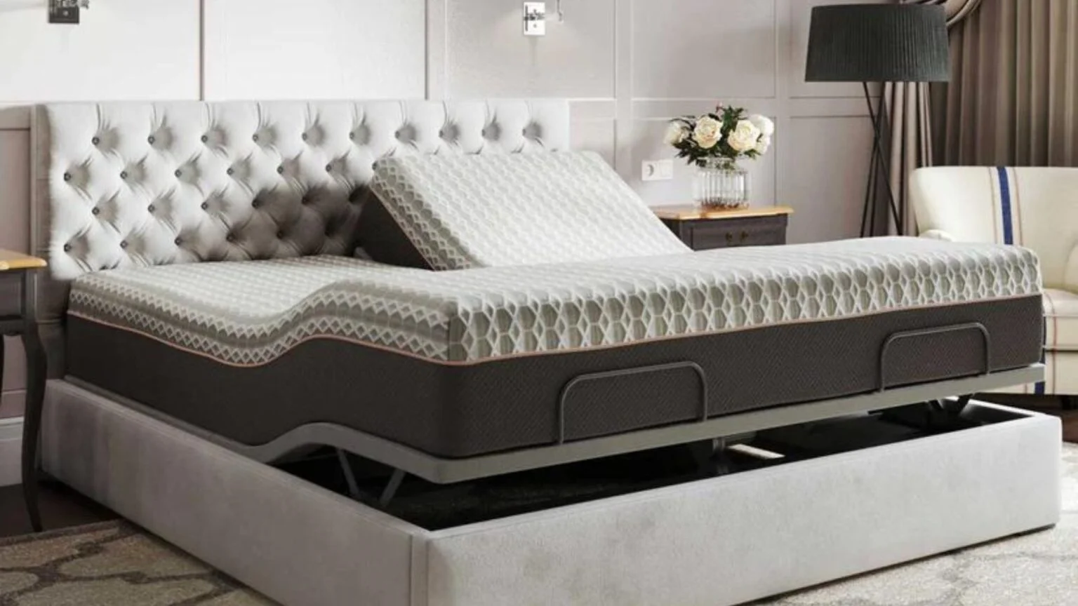 Modern adjustable bed with tufted headboard, bedside table, flowers, and ambient lighting.