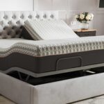 Modern adjustable bed with gray tufted headboard in stylish tranquil bedroom setting.