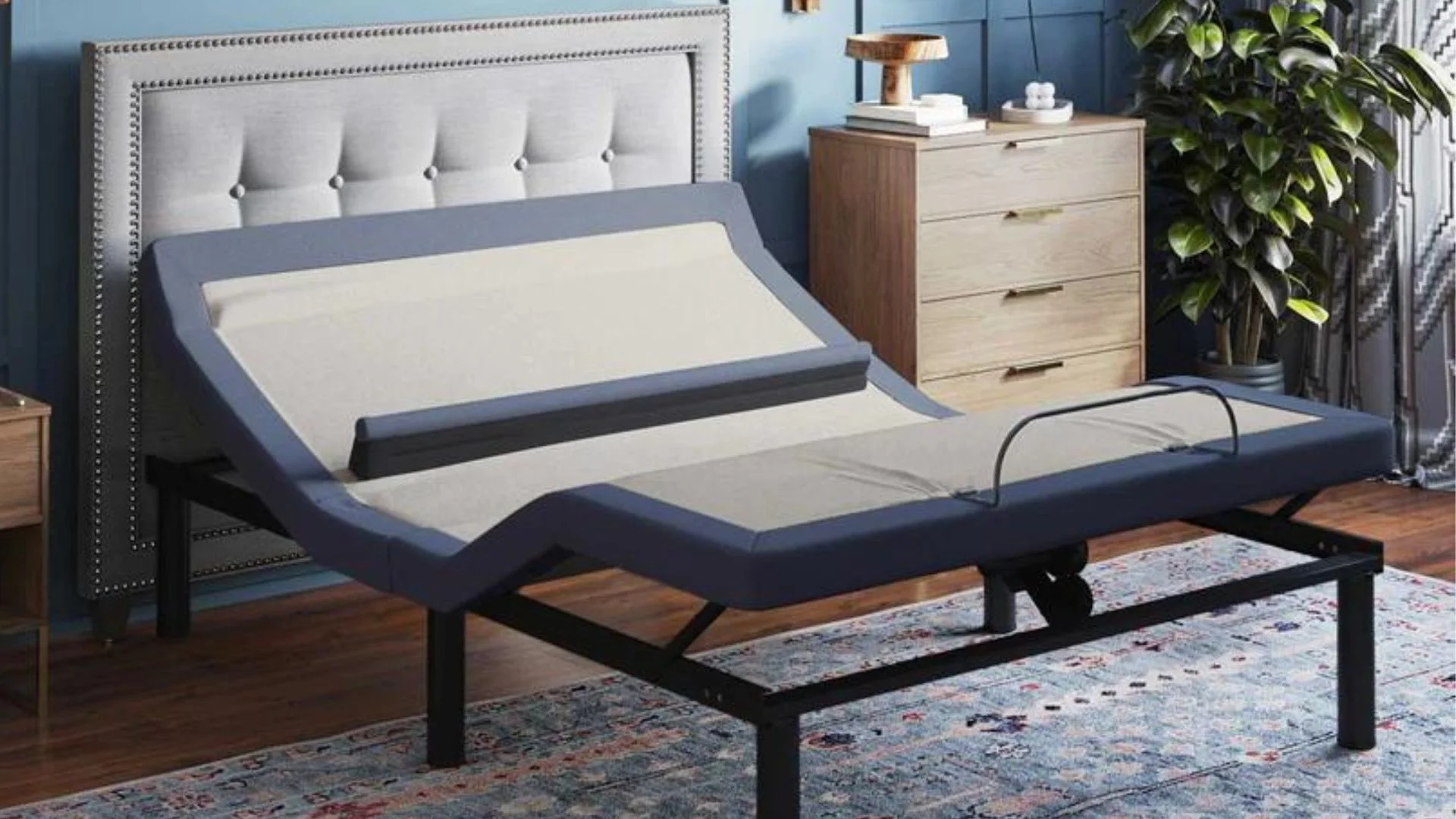 Modern adjustable bed with tufted headboard in a stylish, cozy bedroom setting.