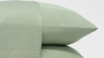 Light green pillows for a serene, minimalist bedroom ambiance.