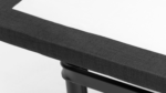 Modern rectangular table with textured black border and light centerpiece, contemporary design.