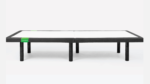 Modern minimalist bed frame with black and white contrast, elevated by black cylindrical legs.