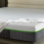 Modern bedroom with elegant mattress design, green trim, and minimalist decor for tranquil relaxation.