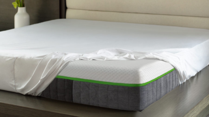 Modern bedroom with elegant mattress design, green trim, and minimalist decor for tranquil relaxation.