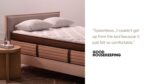Modern bedroom with luxury bed, quilted mattress, wooden headboard, and elegant lighting.