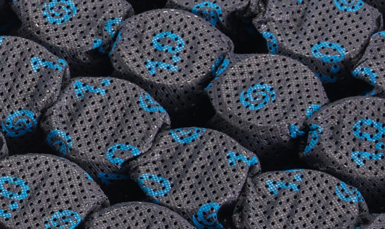 Close-up of black mesh spheres with blue patterns, highlighting texture and potential functional use.