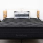 Modern bedroom with Chalet plush mattress, charcoal gray, minimalist design, serene ambiance.