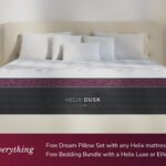 Modern bedroom with Helix Dusk mattress, burgundy accents, cozy pillows, and ambient lighting.