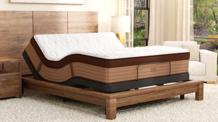 Elegant adjustable mattress on wooden bed in cozy, serene bedroom with natural light and soft tones.
