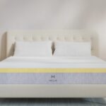 Minimalist bedroom featuring a modern Helix mattress with plush headboard and stylish nightstands.