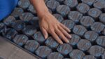 Close-up of ergonomic mattress with grid pockets for enhanced comfort and airflow.