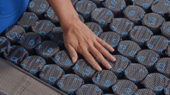 Close-up of ergonomic mattress with grid pockets for enhanced comfort and airflow.