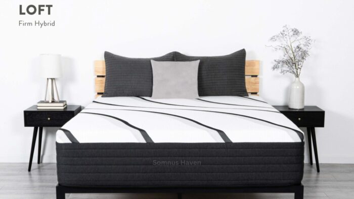 Modern bedroom with LOFT Firm Hybrid mattress, gray pillows, wooden bed, and nightstands.