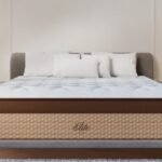 Luxurious bedroom with tufted mattress, gray headboard, modern bedside tables, and soft lighting.