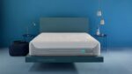 Modern minimalist bedroom with blue accent wall, floating bed, and stylish nightstands.