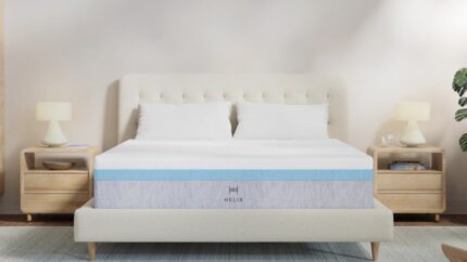Modern bedroom with plush bed, light gray mattress, wood nightstands, and cozy lighting.