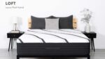 Luxurious modern bedroom with hybrid mattress, wood slat headboard, gray pillows, and elegant decor.
