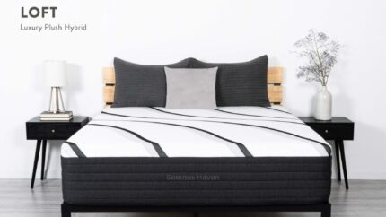 Luxurious modern bedroom with hybrid mattress, wood slat headboard, gray pillows, and elegant decor.
