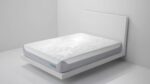Modern minimalist bedroom with sleek white platform bed and quilted mattress.