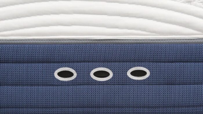 Navy blue mattress with ventilation holes and quilted top for comfort and style.