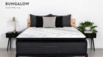 Stylish bedroom with plush bed, wooden headboard, nightstands, and green plant accents.