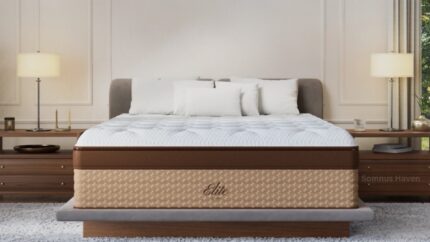 Elegant modern bedroom with cozy gray bed, plush quilt, stylish lamps, and serene ambiance.