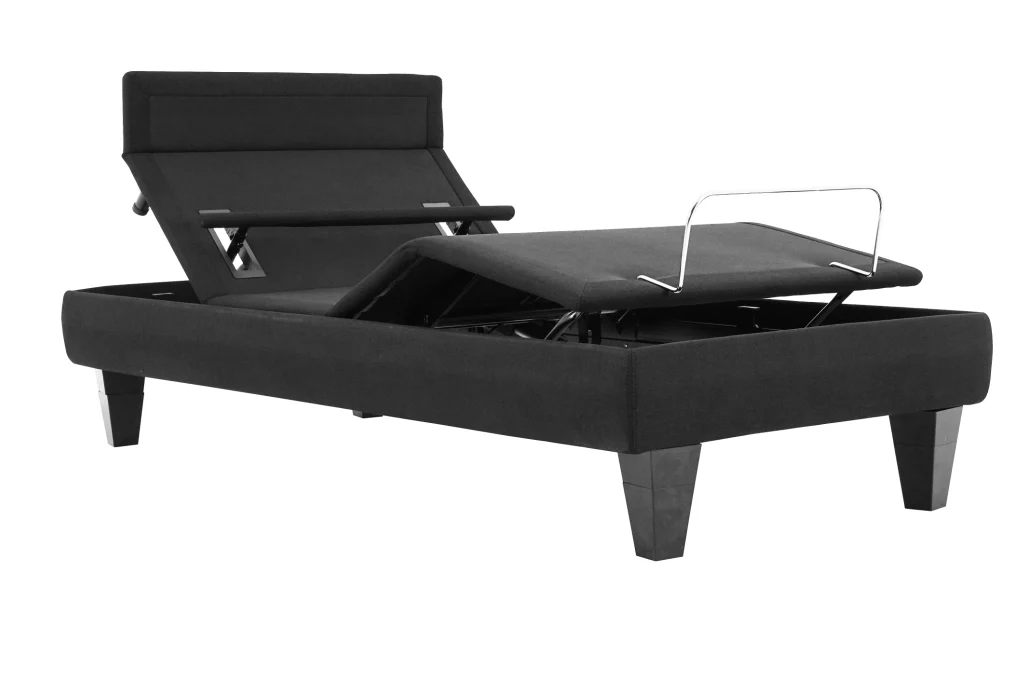Modern adjustable black bed frame with sleek upholstery, remote control, and tapered legs.