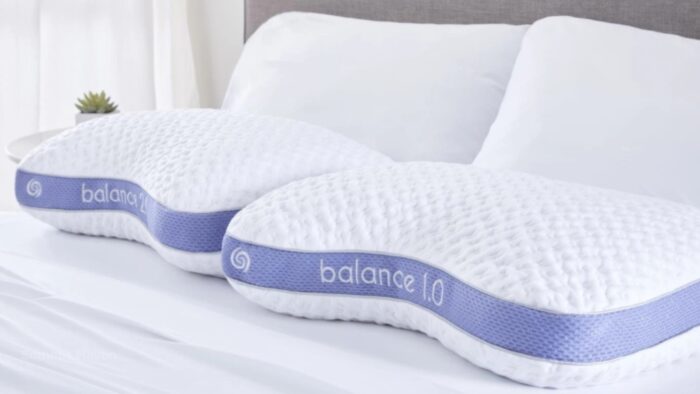 Ergonomic Balance 1.0 pillows with lavender trim on a serene, fresh bedroom setup.