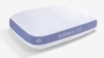 Ergonomic pillow with crisscross top, lavender-gray sides, supporting all sleep positions.