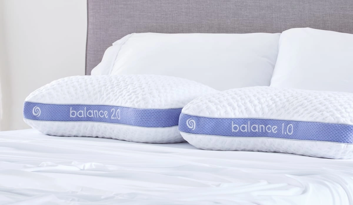 Modern bedroom with Balance pillows for enhanced sleep comfort against a calming gray backdrop.