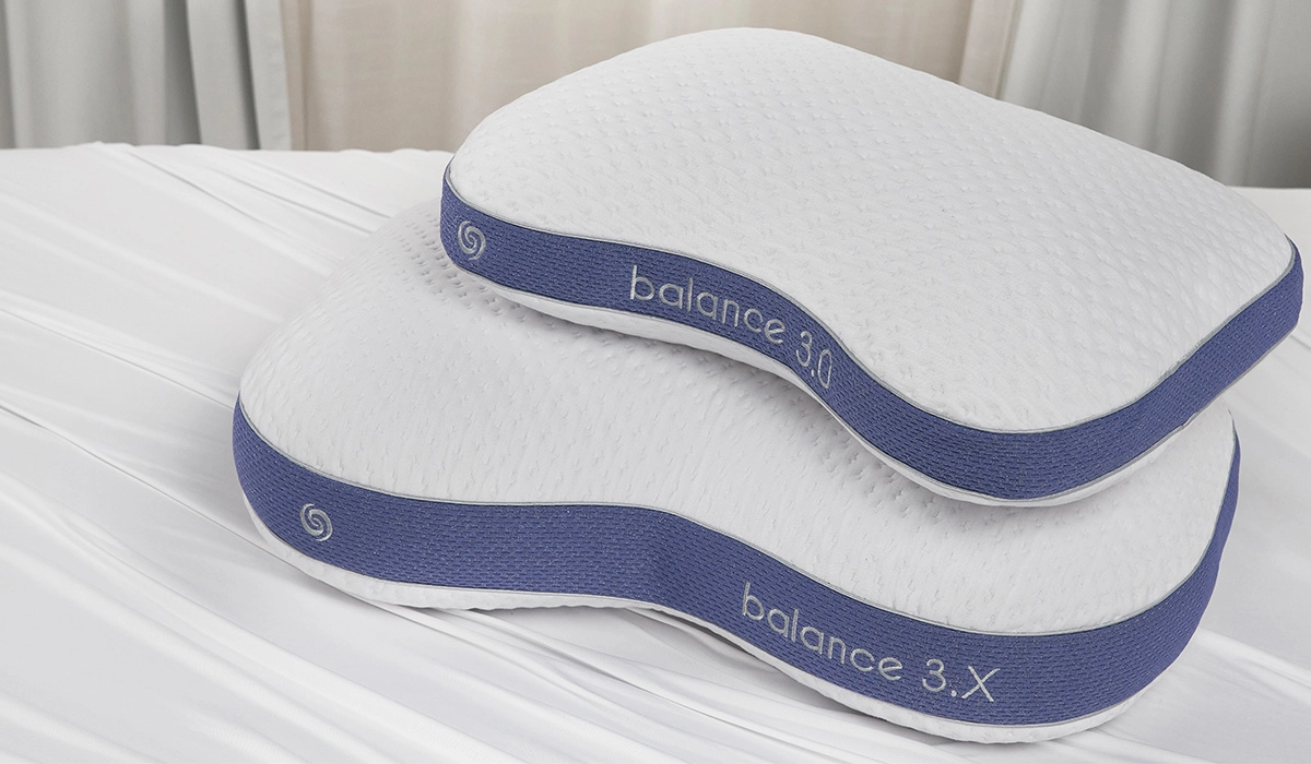 Two contoured ergonomic pillows with blue accents for improved sleep, featuring balance 3.0 stitching.