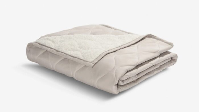 Luxurious beige blanket with quilted and sherpa textures for warmth and style.