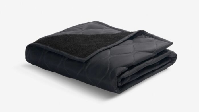 Black quilted blanket with plush texture for warmth and comfort, ideal for stylish home décor.