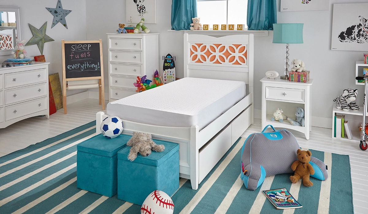 Vibrant childs bedroom with orange geometric headboard, turquoise lamp, and playful decor.