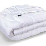 Luxurious white comforter, soft quilted design, easy maintenance, ideal for modern bedroom decor.
