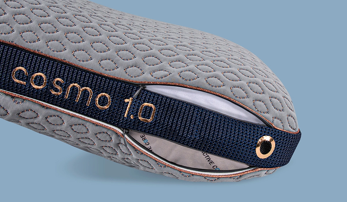 Light gray inflatable cushion with honeycomb design, navy strap, and grommet for outdoor enthusiasts.
