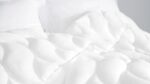 Cozy modern bedding with textured duvet and plush pillows for restful sleep.