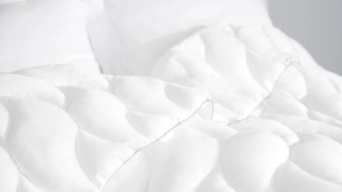 Cozy modern bedding with textured duvet and plush pillows for restful sleep.