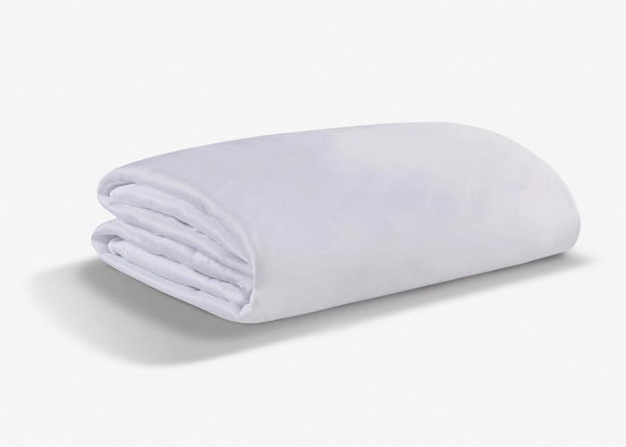 Soft, plush white blanket folded, exuding comfort and warmth for versatile home decor.