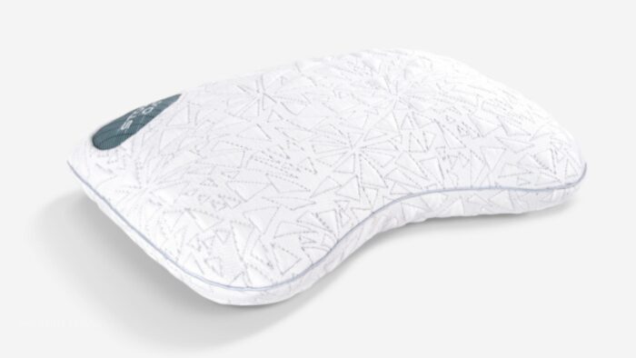 Ergonomic white pillow with wave design for head and neck support, featuring geometric texture.
