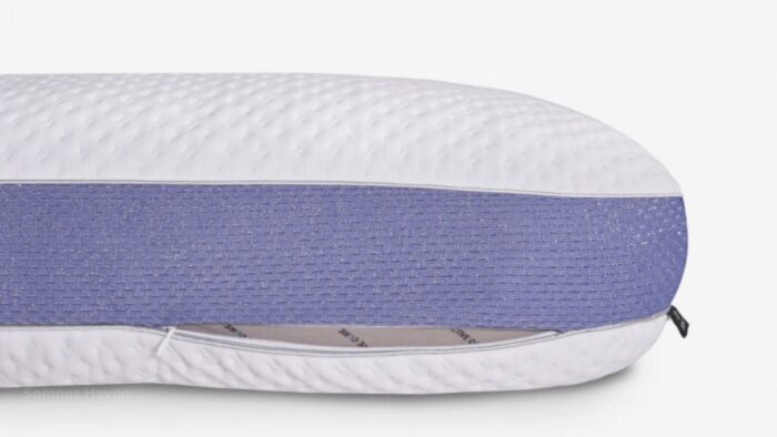 Ergonomic pillow with white textured fabric, lavender accent, and easy-maintenance zipper.