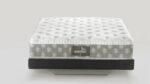 Sleek modern mattress: quilted white top, gray sides, ergonomic, on dark base for elegance.