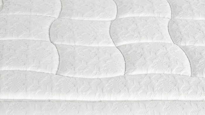 Plush white mattress with intricate quilting for luxurious bedroom decor and restful sleep.